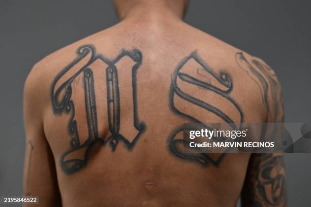 Mara Salvatrucha gang member sentenced to more than 200 years in prison shows off his tattoos alluding to his gang inside the Counter-Terrorism...