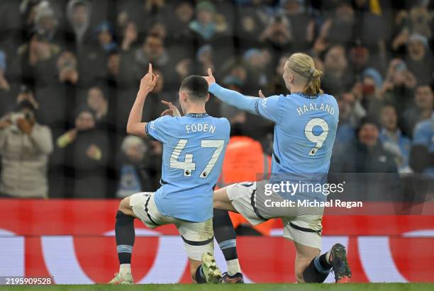 Phil Foden of Manchester City celebrates scoring his team's third goal with teammate Erling Haaland during the Premier League match between...