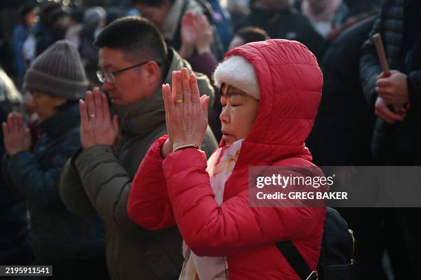 People offer prayers at the Lama Temple on the first day of the Lunar New Year of the Snake in Beijing on January 29, 2025. Hundreds of millions of...