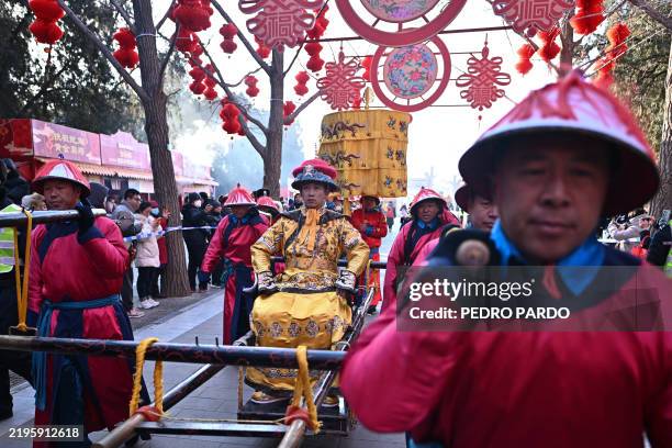 Performer dressed as a Qing Dynasty emperor takes part in a reenactment of a sacrifice ceremony at the Ditan Park Temple Fair in Beijing on January...