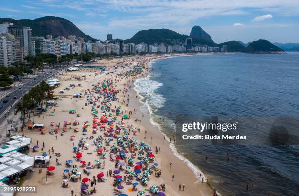 Aerial view as people cool down at Copacabana Beach on January 25, 2025 in Rio de Janeiro, Brazil. Rio The city reached a maximum temperature of 38°C...