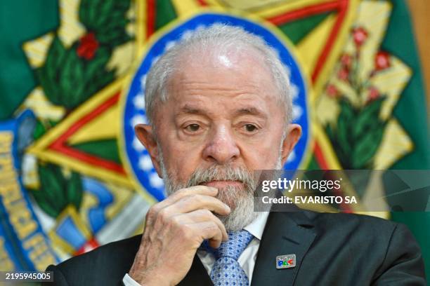 Brazil's President Luiz Inacio Lula da Silva gestures during an announcement of investment in road improvements at the Planalto Palace in Brasilia on...