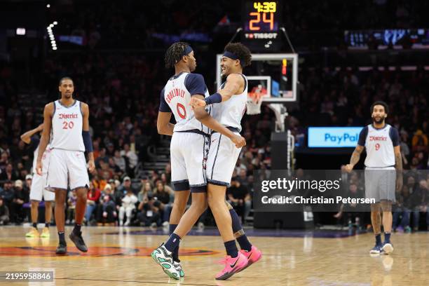 Jordan Poole and Bilal Coulibaly of the Washington Wizards react after an alley-oop dunk against the Phoenix Suns during the first half of the NBA...