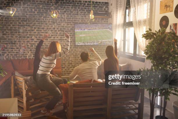 group of young fans watching a match on tv in a café - rugby sport stock pictures, royalty-free photos & images