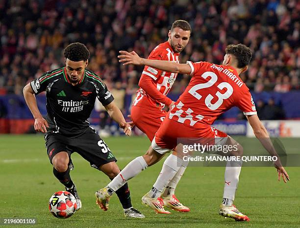 Arsenal's English midfielder Ethan Nwaneri fights for the ball with Girona's Spanish midfielder Ivan Martin during the UEFA Champions League, league...