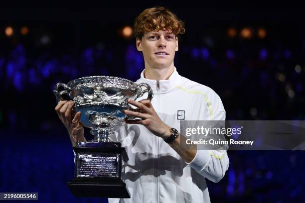 Jannik Sinner of Italy poses with the Norman Brookes Challenge Cup at the Men's Singles trophy presentation following the Men's Singles final against...