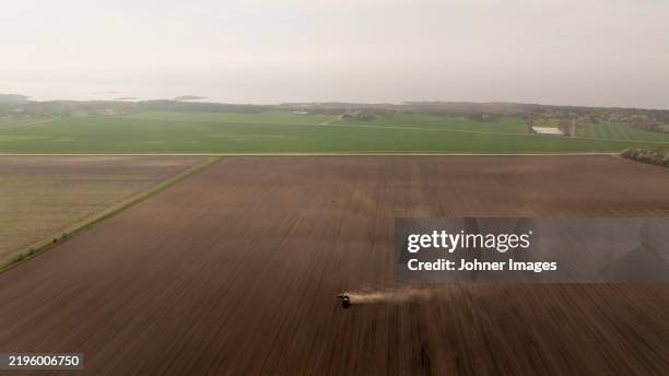 drone point of view of plowed agricultural field at foggy day - plowed field stock pictures, royalty-free photos & images