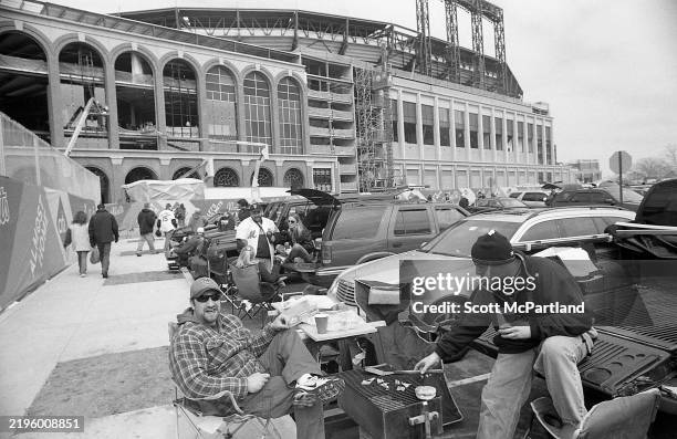 Before the final home opener , baseball fans tailgate in a parking lot outside Shea Stadium, in Queens' Corona neighborhood, New York, New York,...