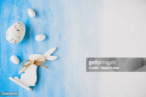 easter bunny and quail eggs on a blue and white surface. - easter wishes stock pictures, royalty-free photos & images