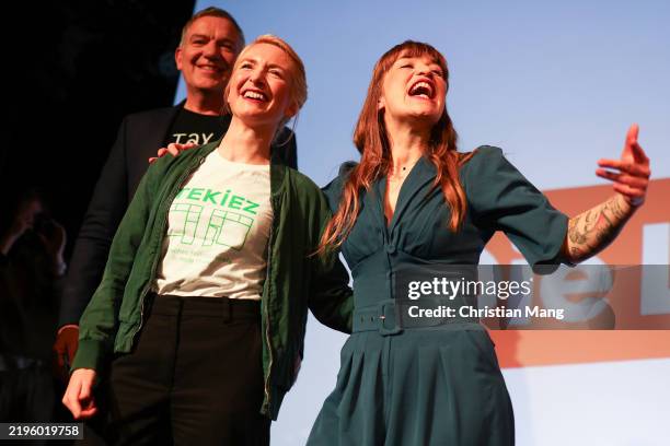 Jan van Aken and Ines Schwerdtner , co-leader of the leftist Die Linke political party and Heidi Reichinnek , react to supporters at the party's...