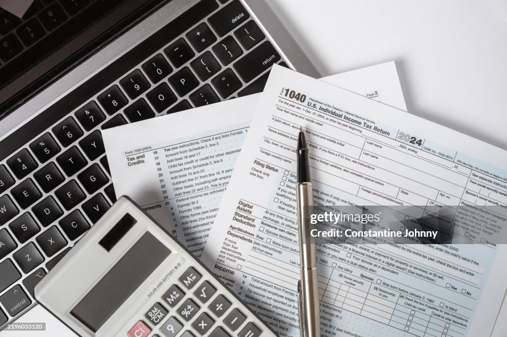 1040 Tax Form with Laptop and Calculator