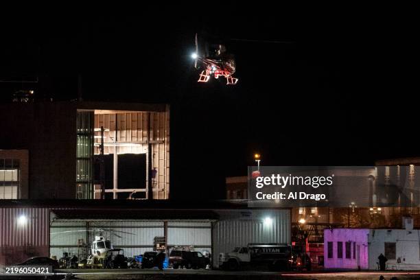 Helicopter aids in search and rescue operations in the Potomac River near Ronald Reagan Washington Airport on January 29, 2025 in Washington, DC. An...