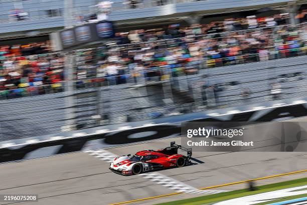 Felipe Nasr, driver of the Porsche Penske Motorsports Porsche 963 crosses the finish line to win the Rolex 24 at Daytona International Speedway on...