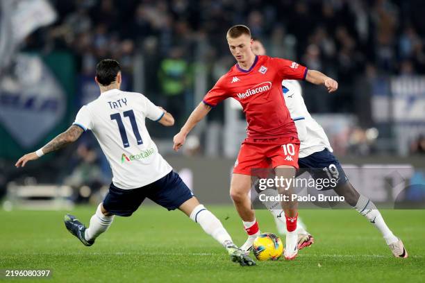 Albert Gudmundsson of Fiorentina is challenged by Valentin Castellanos of Lazio during the Serie A match between SS Lazio and Fiorentina at Stadio...