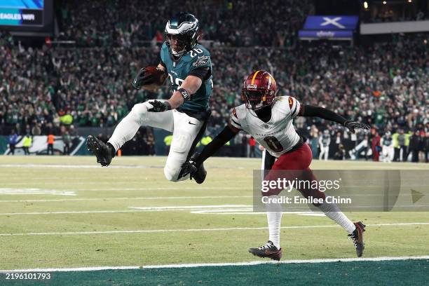 Saquon Barkley of the Philadelphia Eagles scores a touchdown against Mike Sainristil of the Washington Commanders during the fourth quarter in the...