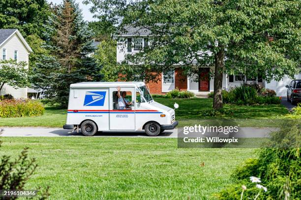 usps mailman postal van driver waving out window - postbode stockfoto's en -beelden