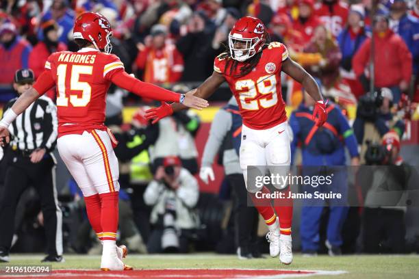 Kareem Hunt of the Kansas City Chiefs celebrates his touchdown run with Patrick Mahomes during the first quarter against the Buffalo Bills in the AFC...