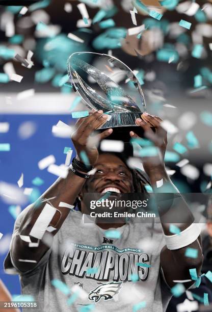 Brown of the Philadelphia Eagles celebrates with the George Halas Trophy after defeating the Washington Commanders 55-23 to win the NFC Championship...