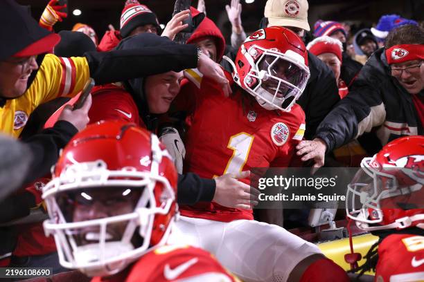 Xavier Worthy of the Kansas City Chiefs jumps into the stands after scoring a touchdown during the second quarter against the Buffalo Bills in the...