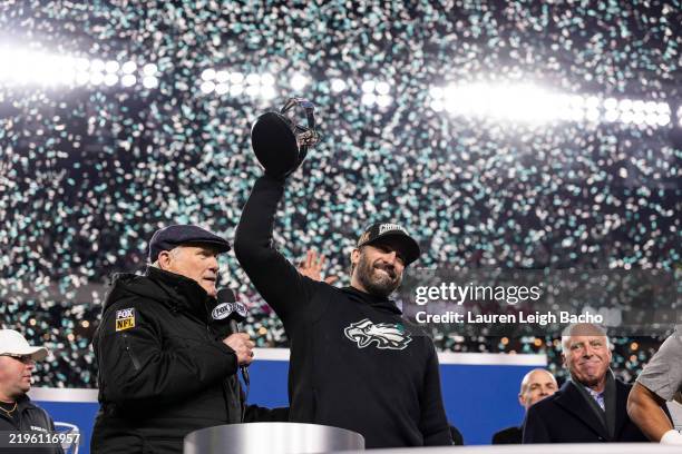 Head coach Nick Sirianni of the Philadelphia Eagles holds up the NFC Champion trophy after the game against the Washington Commanders at Lincoln...