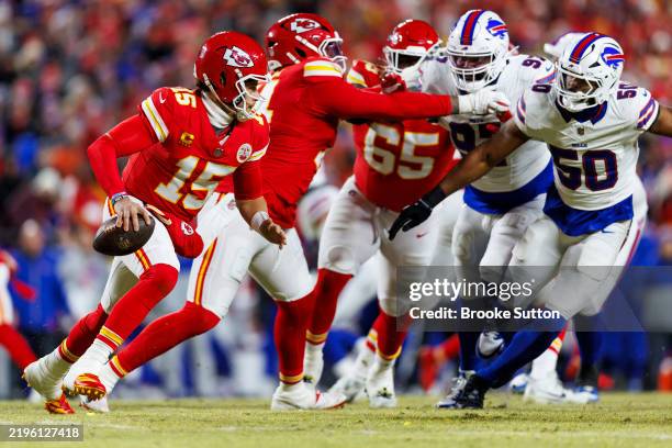 Quarterback Patrick Mahomes of the Kansas City Chiefs scrambles out of the pocket during the first half of the AFC Championship football game against...