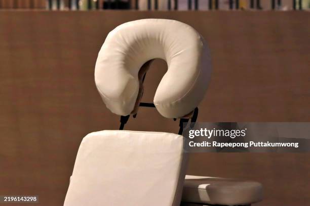beige headrest on a massage table close-up. - kopfstütze stock-fotos und bilder