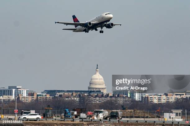 Plane takes off from Reagan National Airport after the crash last night of an American Airlines plane on the Potomac River as it approached the...