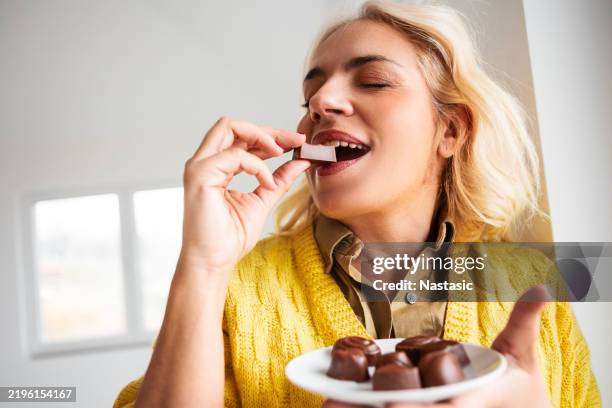 a woman’s love for chocolate - sugar food stock pictures, royalty-free photos & images