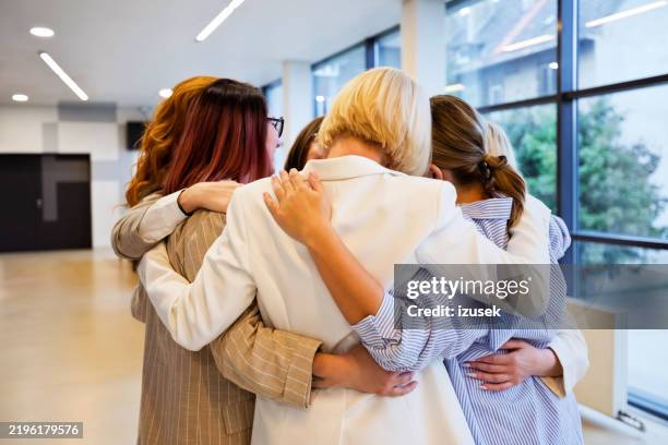 businesswomen standing in the circle and hugging - support stock pictures, royalty-free photos & images