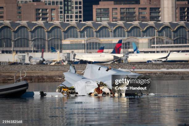 In this U.S. Coast Guard handout, the Coast Guard investigates aircraft wreckage on the Potomac River on January 30, 2025 in Washington, DC. An...