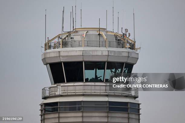 Man gestures inside the control tower of Reagan National Airport after an American Airlines flight crashed into the river after colliding with a US...