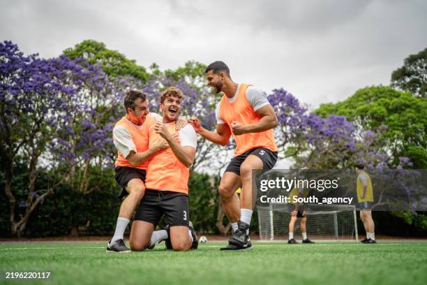 men celebrate teamwork during a soccer practice session in sydney, showcasing camaraderie and excitement among the players - soccer team celebrating stock pictures, royalty-free photos & images