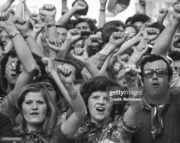 Left Wingers give the clenched ist salute duing a Communist regional election victory celebration outside the basilica of St. John's. The Communists...