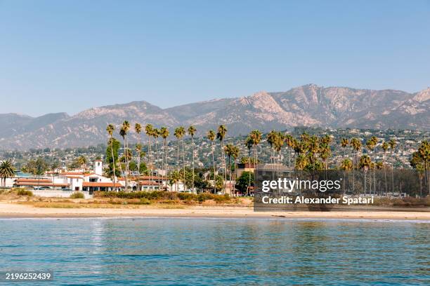 santa barbara skyline and beach lined up with palm trees, california, usa - santa barbara imagens e fotografias de stock