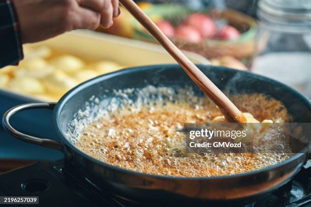 preparing tarte tatin with caramelized apples in domestic kitchen - tarte tatin stockfoto's en -beelden