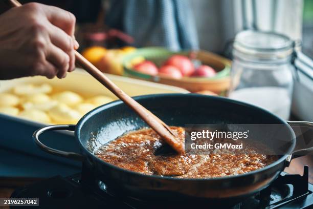 preparing tarte tatin with caramelized apples in domestic kitchen - tarte tatin stock-fotos und bilder