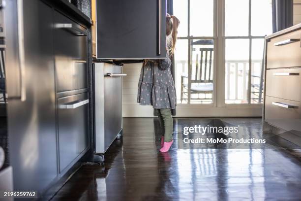 toddler girl looking in refrigerator at home - tip toe stock pictures, royalty-free photos & images