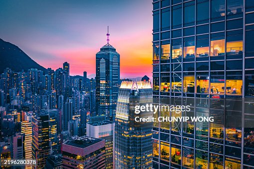 Hong kong skyline showing modern skyscrapers at sunset Hong kong skyline showing modern skyscrapers at sunset