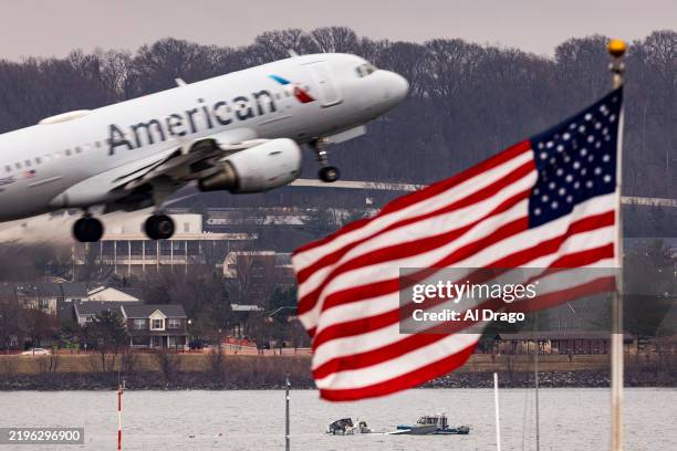 Recovery teams search the wreckage after the crash of an American Airlines plane on the Potomac River as it approached the airport on January 31,...