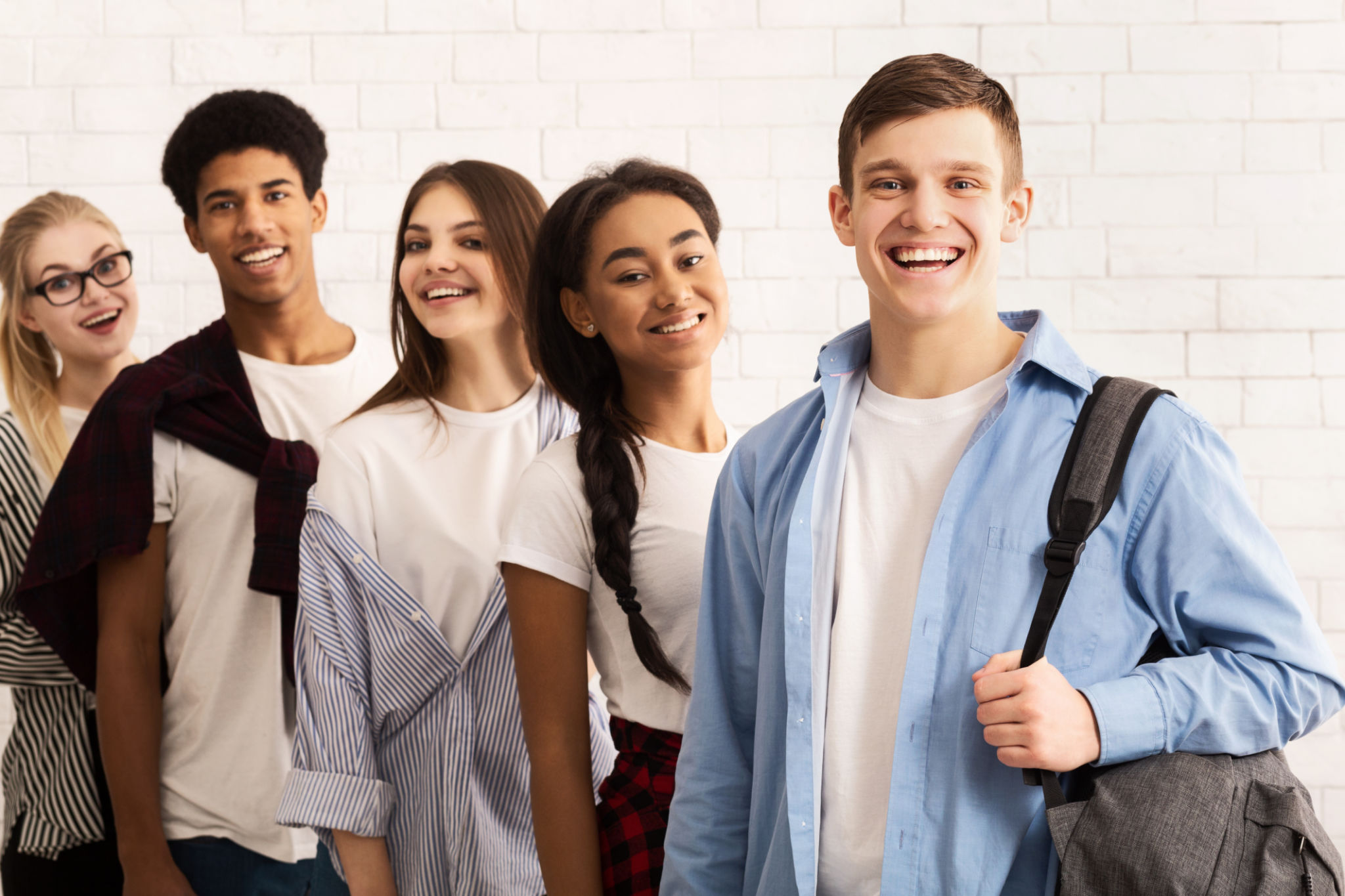 Group of Cheerful Friends Standing Together in a Modern Indoor Space During Daytime Group of Cheerful Friends Standing Together in a Modern Indoor Space During Daytime