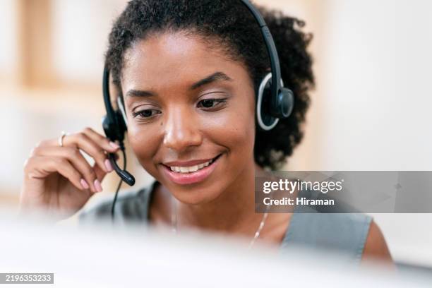 friendly customer support agent working in a call center environment - customer experience stock pictures, royalty-free photos & images