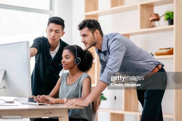 team collaboration in office setting focused on computer task - literacy stock pictures, royalty-free photos & images