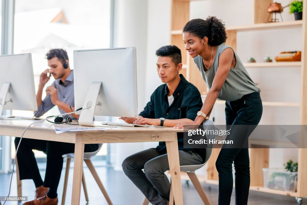 Collaborative Team in a Bright Office Environment Working on a Project at Their Desks