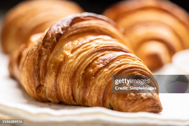 close-up view of a butter croissant made from puff pastry - raisin cake stock pictures, royalty-free photos & images
