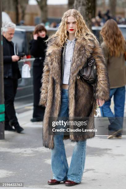 Model wears light blue striped shirt, jeans, brown fur coat, outside Chanel, during Haute Couture Spring-Summer 2025 as part of Paris Fashion Week on...