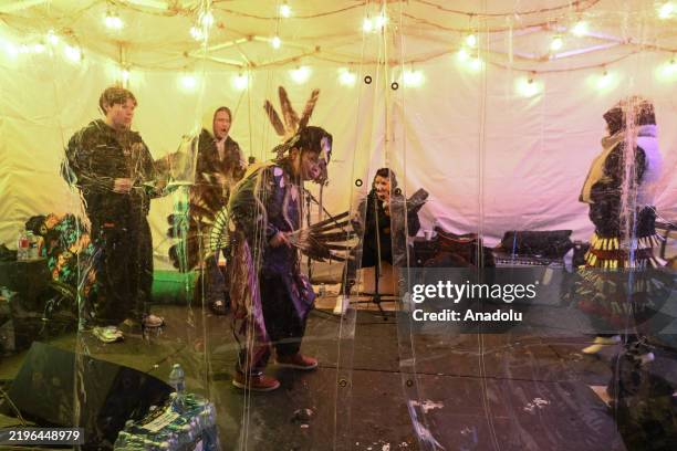 Cree First Nations drummers and dancers perform inside a heated tent at the First Nations Camp, one of the sites of the Flying Canoe Volant festival,...