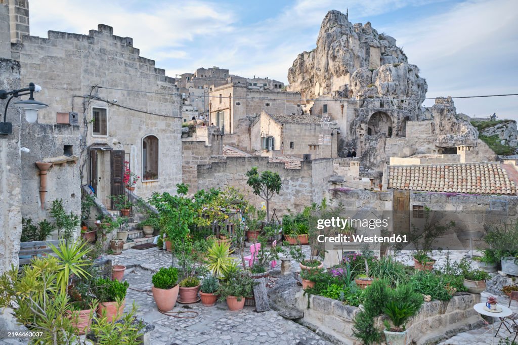 Historic stone buildings and potted plants in Matera, Italy