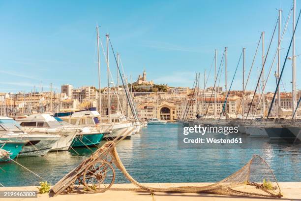 historic port of marseille with the notre-dame de la garde on the top of the hill, marseille, france - marseille stock pictures, royalty-free photos & images