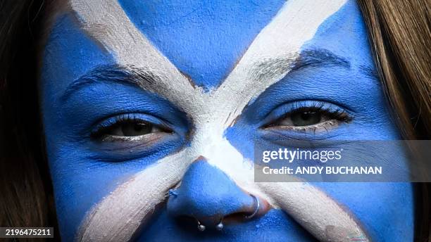 Supporter with her face painted with the Scottish flag colours attends the Six Nations international rugby union match between Scotland and Italy at...