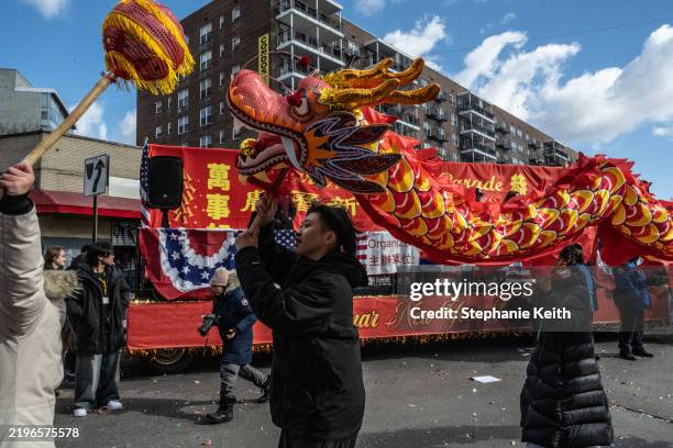 People participate in a parade celebrating the Lunar New Year in the Flushing neighborhood on February 1, 2025 in the Queens borough of New York...